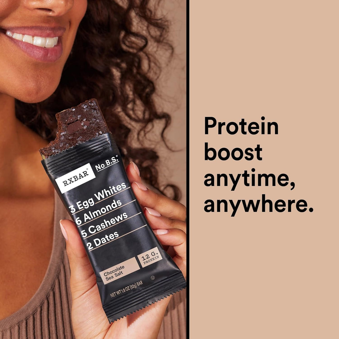 Person holding a protein bar with text 'Protein boost anytime, anywhere.'