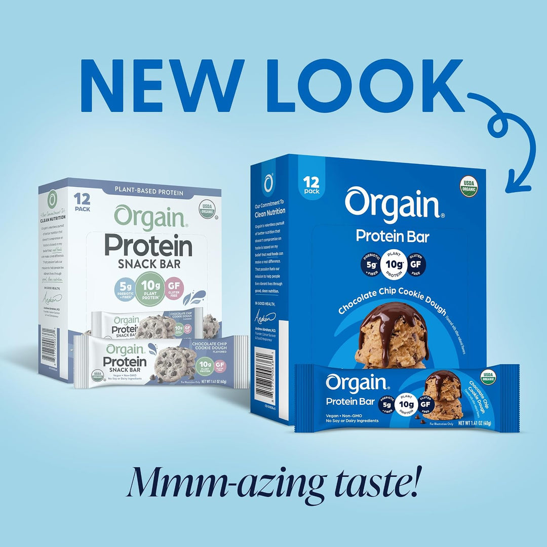Two boxes of Orgain Protein Bar snack bars on a light blue background with promotional text reading 'NEW LOOK' and 'Mmm-azing taste!'. The right box is blue and shows chocolate chip cookie dough flavor, while the left box is white and shows protein snack bar packaging.