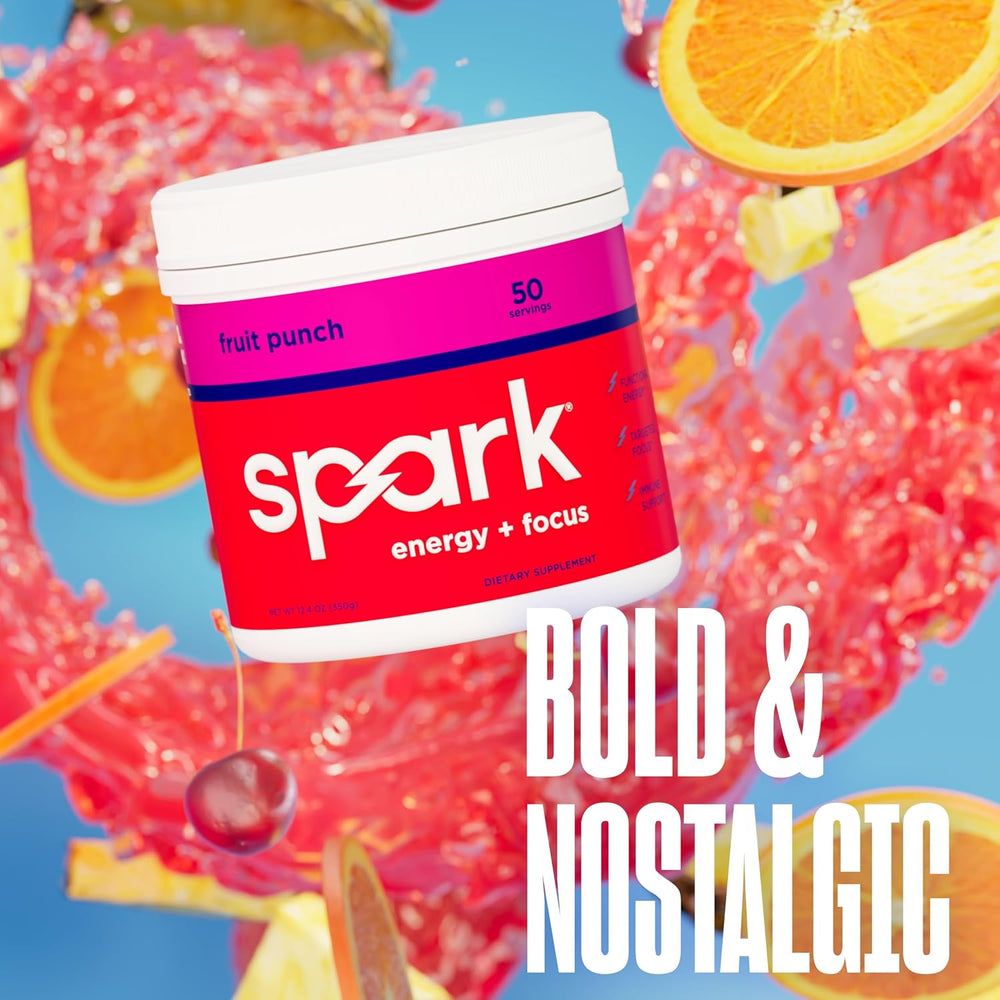 A tub of Spark Energy + Focus supplement in fruit punch flavor, shown floating over a colorful splash background with orange slices, cherries, and large white text reading 'BOLD & NOSTALGIC'.