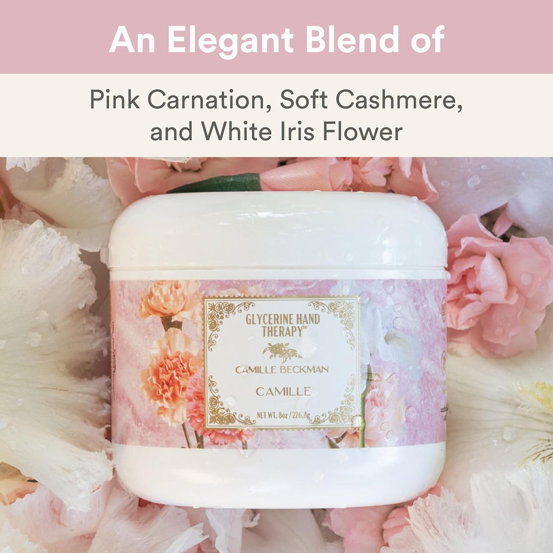 Jar of Camille Beckman Glycerine Hand Therapy with pink carnation, soft cashmere, and white iris flower description on a floral background.