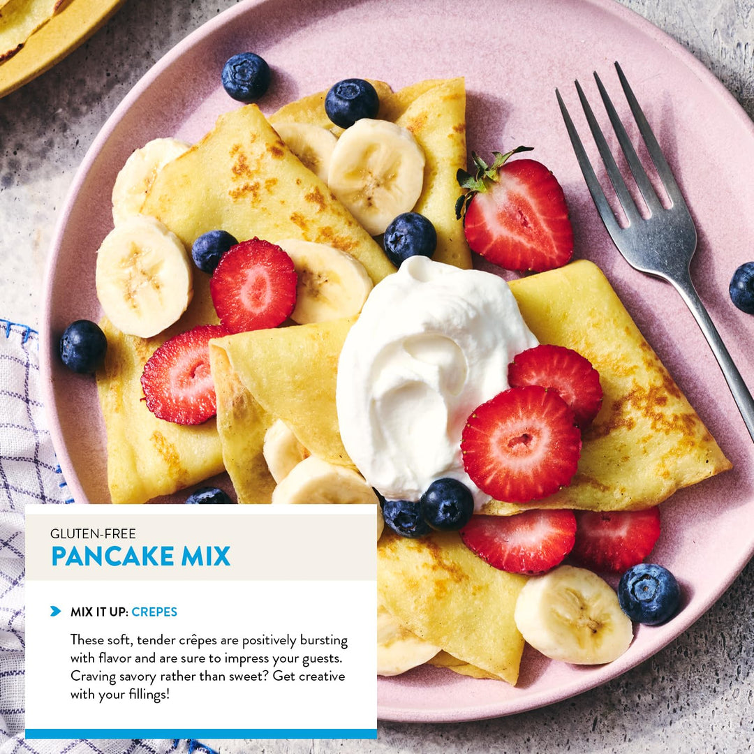 Crepes with fruit on a pink plate with a fork, featuring gluten-free pancake mix text.