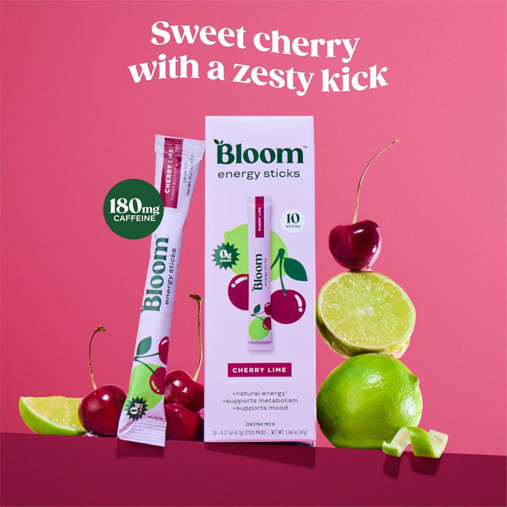 Bloom Energy Sticks Cherry Lime flavor stick packs and box packaging displayed with fresh cherries, limes, and lime slices on a pink background with the text 'Sweet cherry with a zesty kick'.