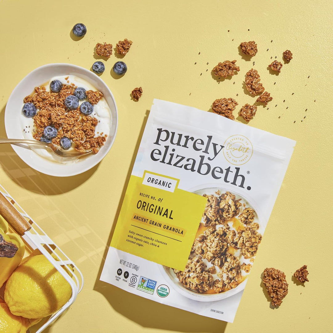 Purely Elizabeth organic ancient grain granola package with a bowl of granola and blueberries on a yellow background